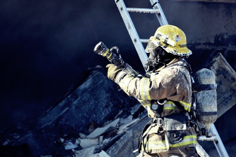 firefighter holding water hose